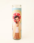 On a white background is a prayer candle with Harry Styles in front of a watermelon on the front.