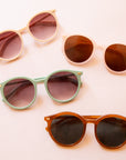 On a peach background is the three Sam sunglasses in the four color ways.