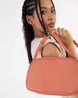 woman wearing coral colored crossbody