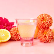 Two of the cocktail tumbler glasses in a clear pink shade.