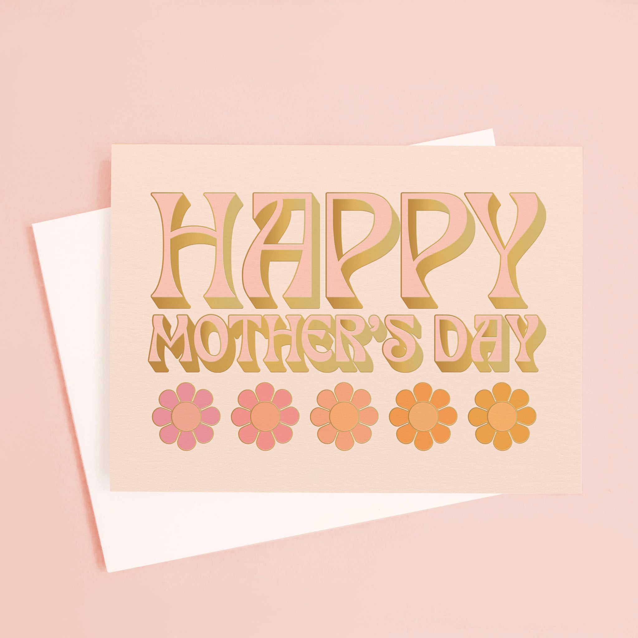 On a peachy background is a light pink card that reads, &quot;Happy Mother&#39;s Day&quot; with five daisies underneath. 