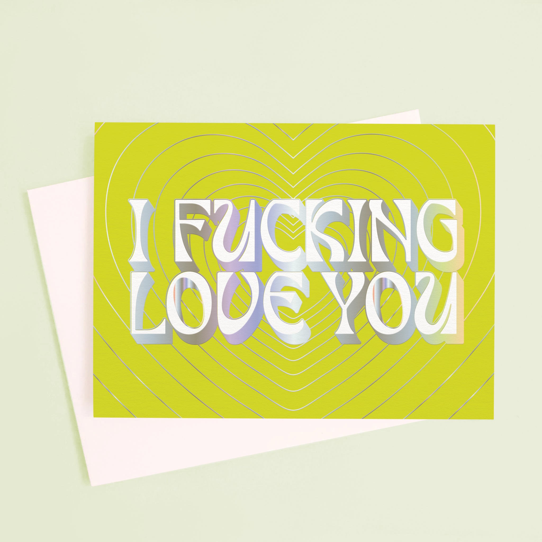On a mint green background is a lime green card with silver heart shapes and text in the center that reads, &quot;I Fucking Love You&quot;.
