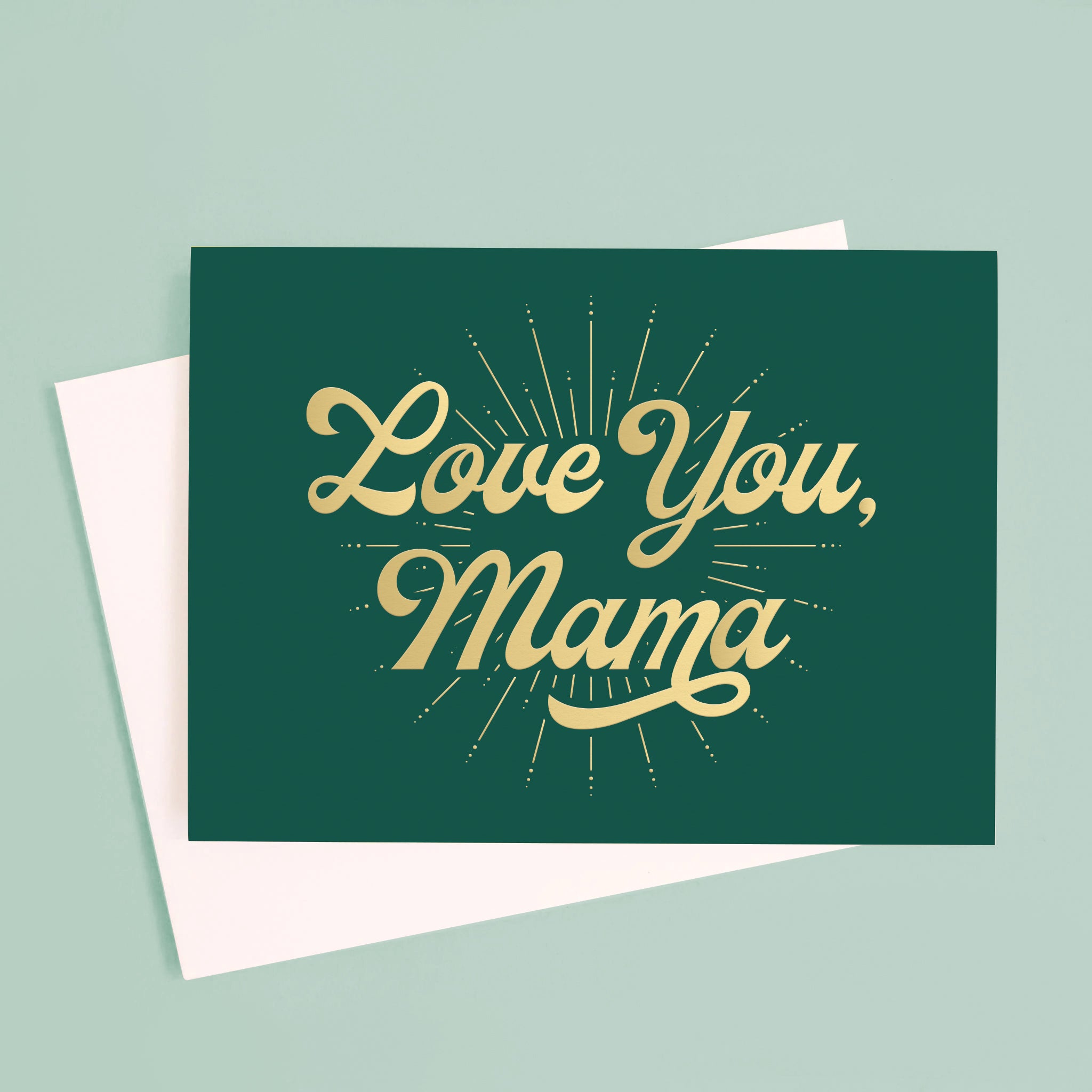 On a blue background is a dark green card with gold foil text that reads, &quot;Love You, Mama&quot;. 