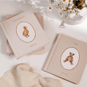 A set of five neutral baby books.