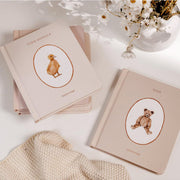 A set of five neutral baby books.