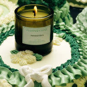 A glass jar candle with a white lablel that reads, 'Flamingo Estate Prinsesstarta'.