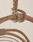 A close up of the rope detailing on the hanging rattan chair.