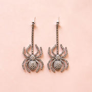 A pair of spider shaped dangle earrings.