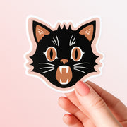 A spooky black and orange Halloween cat sticker.