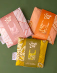 A bundle of three reusable nylon tote bags with different plant patterns on them.