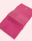 The interior of the pink wallet with 10 card slots and a button closure.