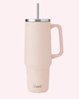 A light pink tumbler with a silver lid and straw.