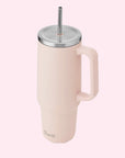 A light pink tumbler with a silver lid and straw.