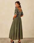 A velvet green dress with short sleeves and a v back.