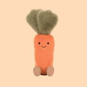 A small carrot shaped stuffed toy with a smiling face.