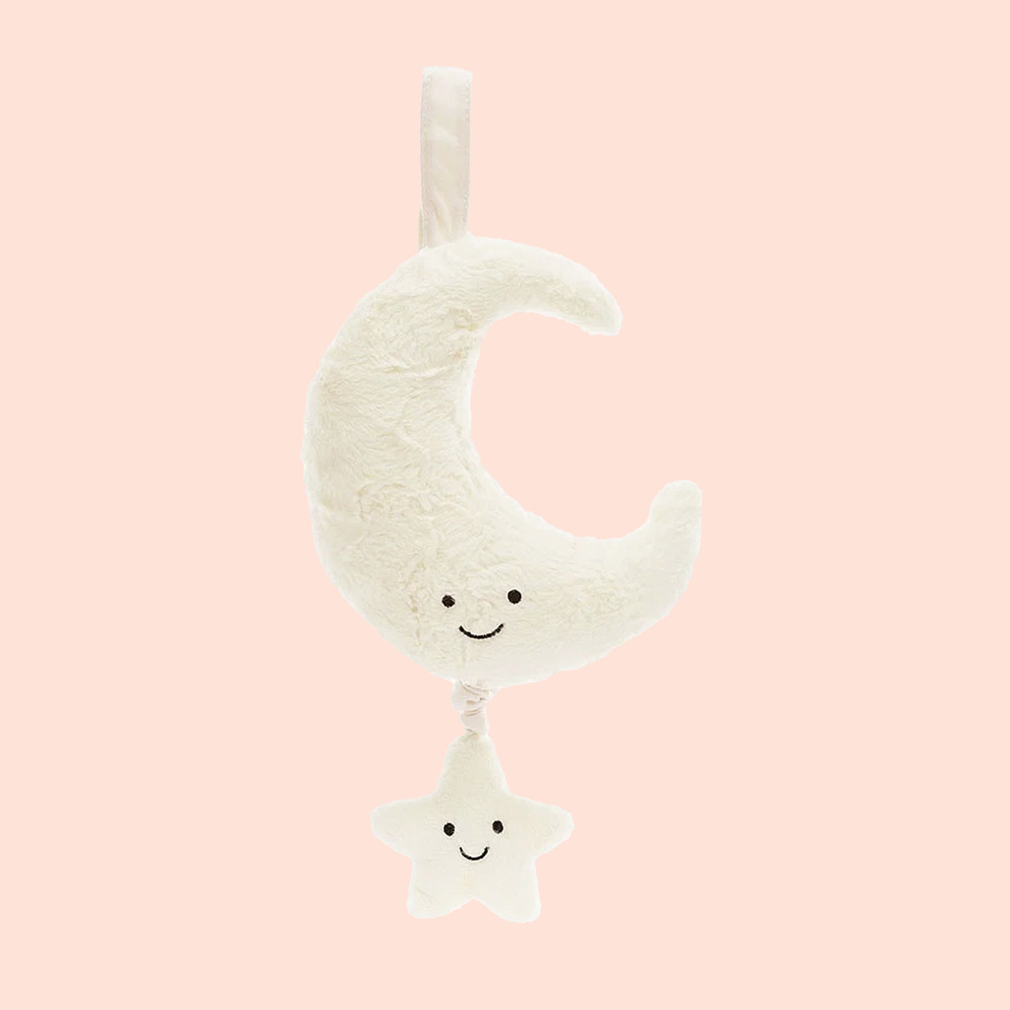 On a pink background is an ivory moon and star shaped musical pull toy. 