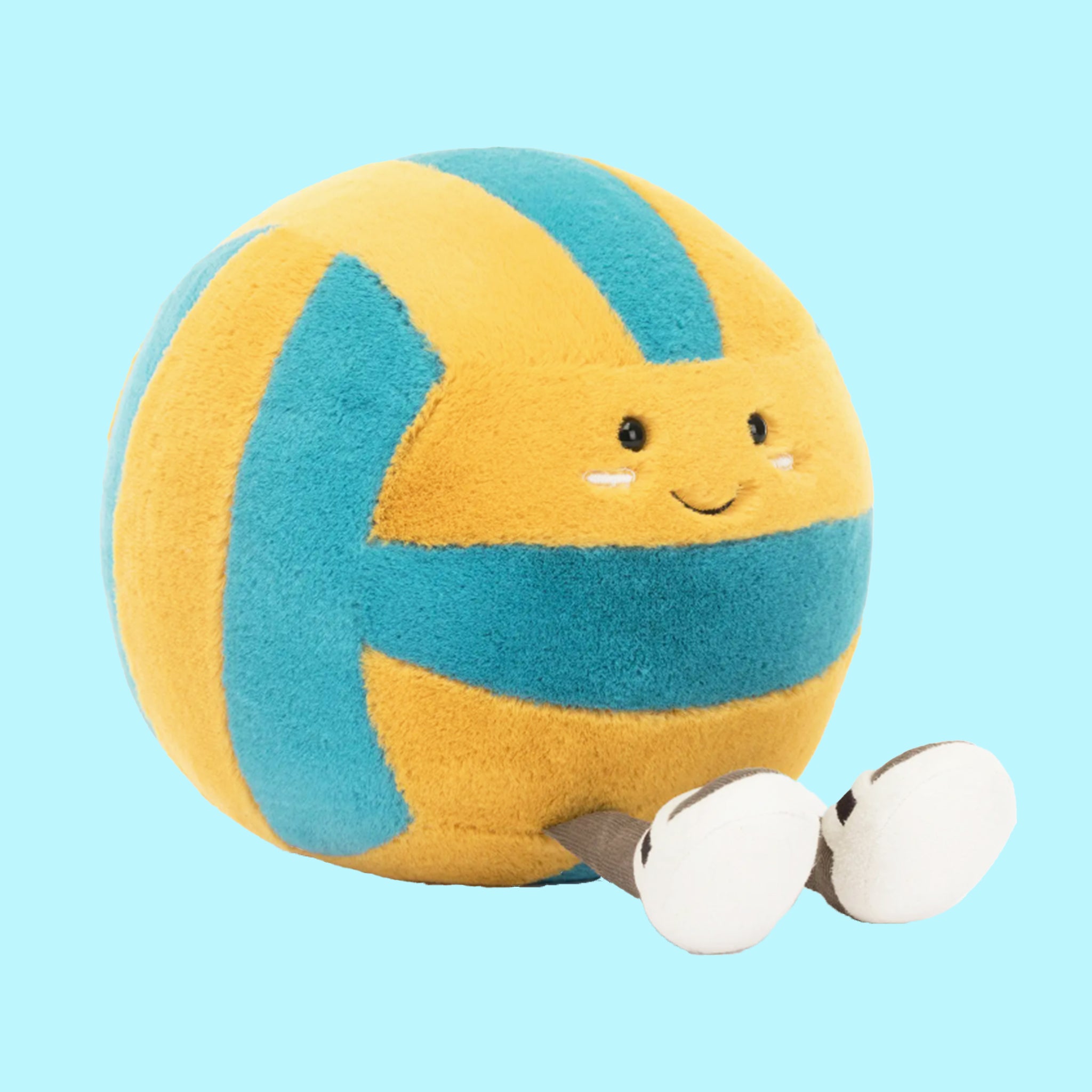 A blue and yellow stuffed toy in the shape of a volleyball with adorable legs, feet and a smiling face. 