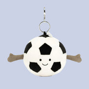 On a blue background is a black and white soccer ball shaped bag charm.
