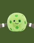 A round pickleball shaped stuffed toy with a smiling face and two arms and hands.