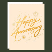 card with gold foil text that reads, "Happy Anniversary" along with gold foil stars, sun and moons around.