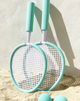 A pair of aqua rackets with two balls.