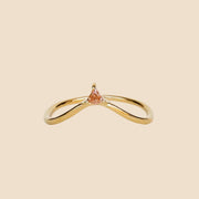 A gold arched ring with a small champagne CZ stone at the top of the arch.