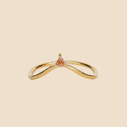 A gold arched ring with a small champagne CZ stone at the top of the arch.