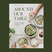 A neutral book cover with plates of prepared food and pasta and text that reads, 'Sprouted Kitchen Around Our Table wholesome recipes to feed your family & friends'.
