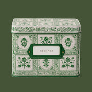 A green and ivory recipe tin with a floral pattern and label in the center that reads, 'Recipes'.