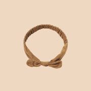 A mustard bow headband.