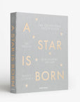A light greyish blue photo album cover with text that reads, 'A Star Is Born'.