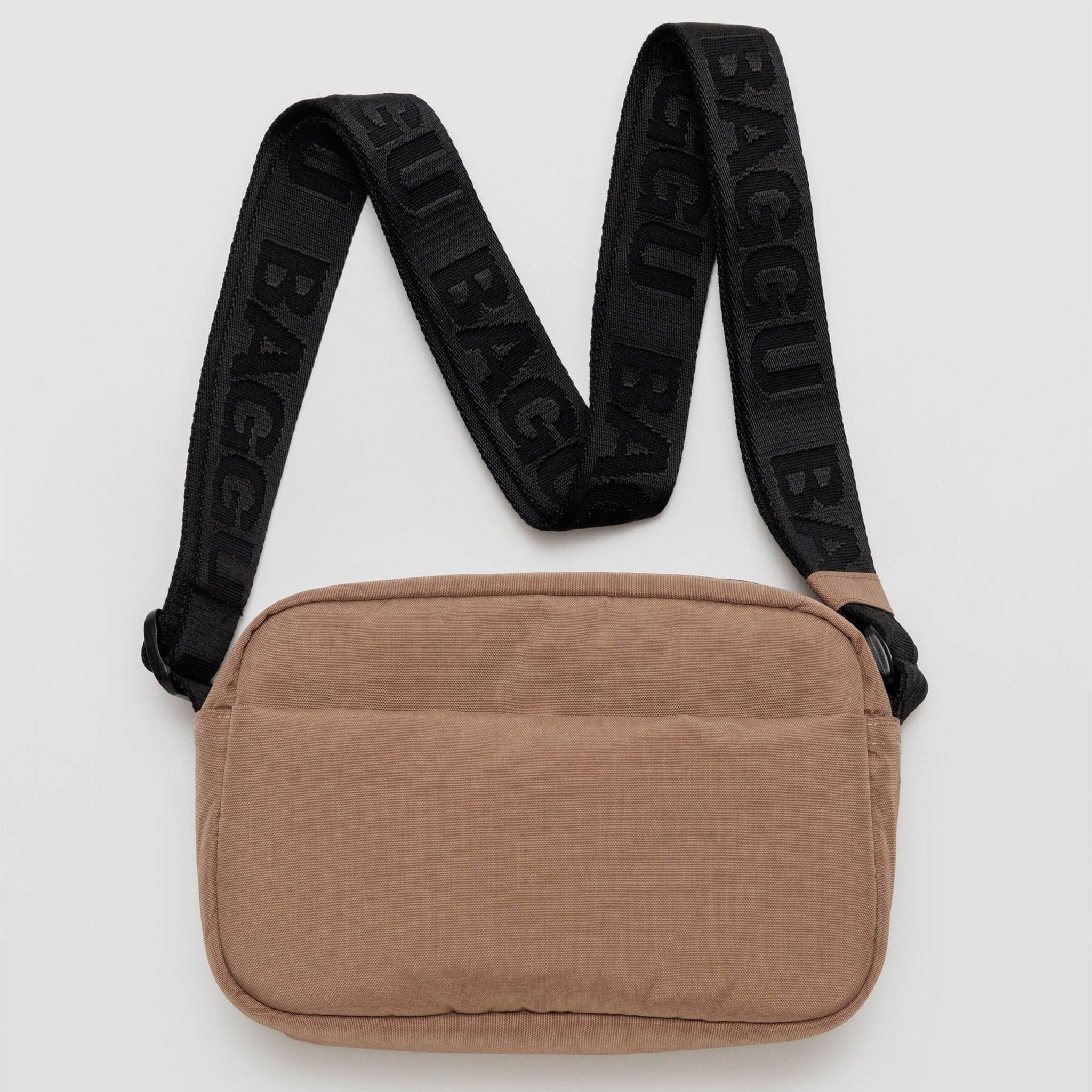 a light brown rectangle shaped bag with front slip pocket and black strap