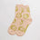 light pink socks with green smiley faces
