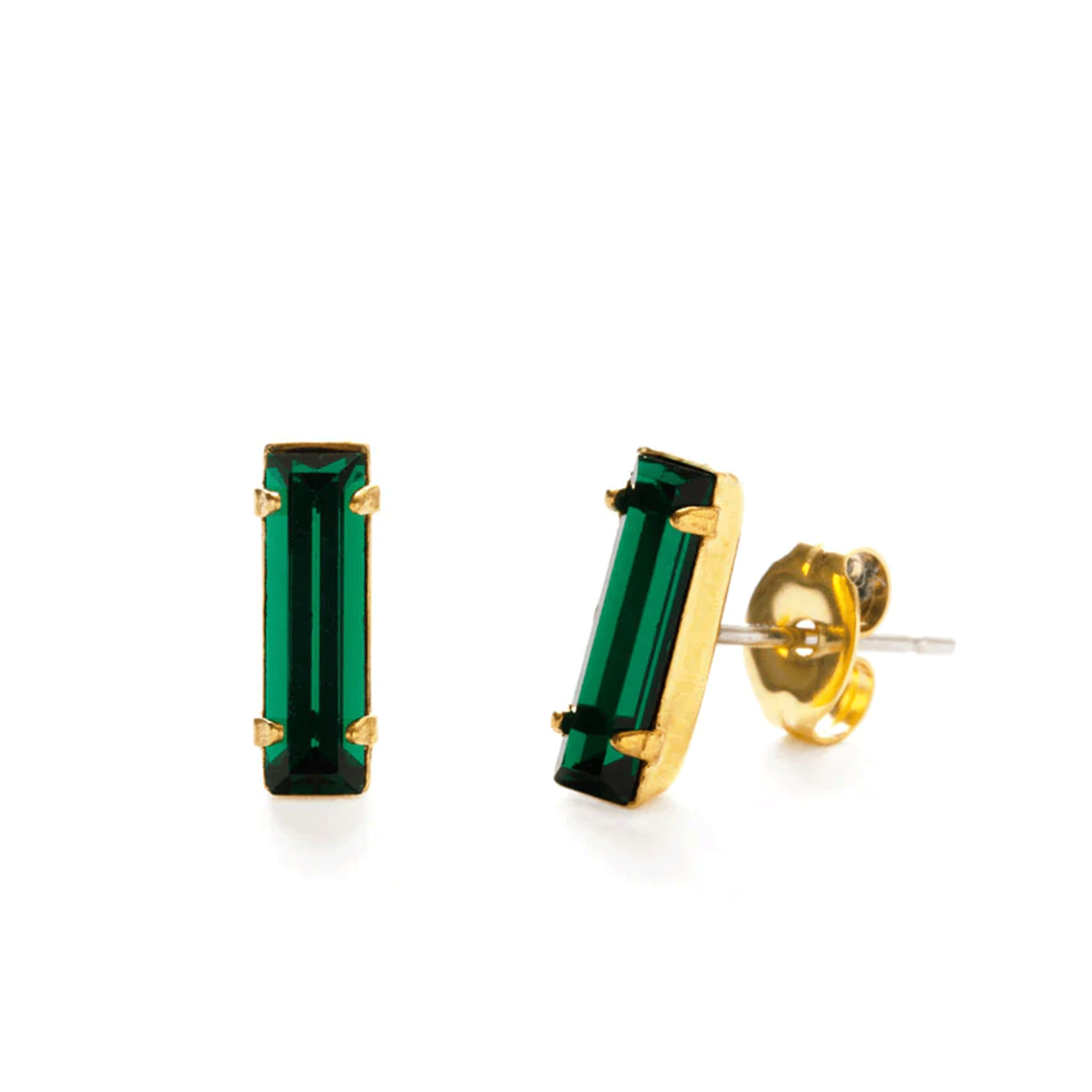 On a white background is a baguette shaped emerald stone stud earrings with gold plated backing. 