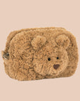 A tan furry pouch with a bear face in the center.