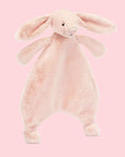 A blush pink bunny shaped furry unstuffed blanket/ toy.