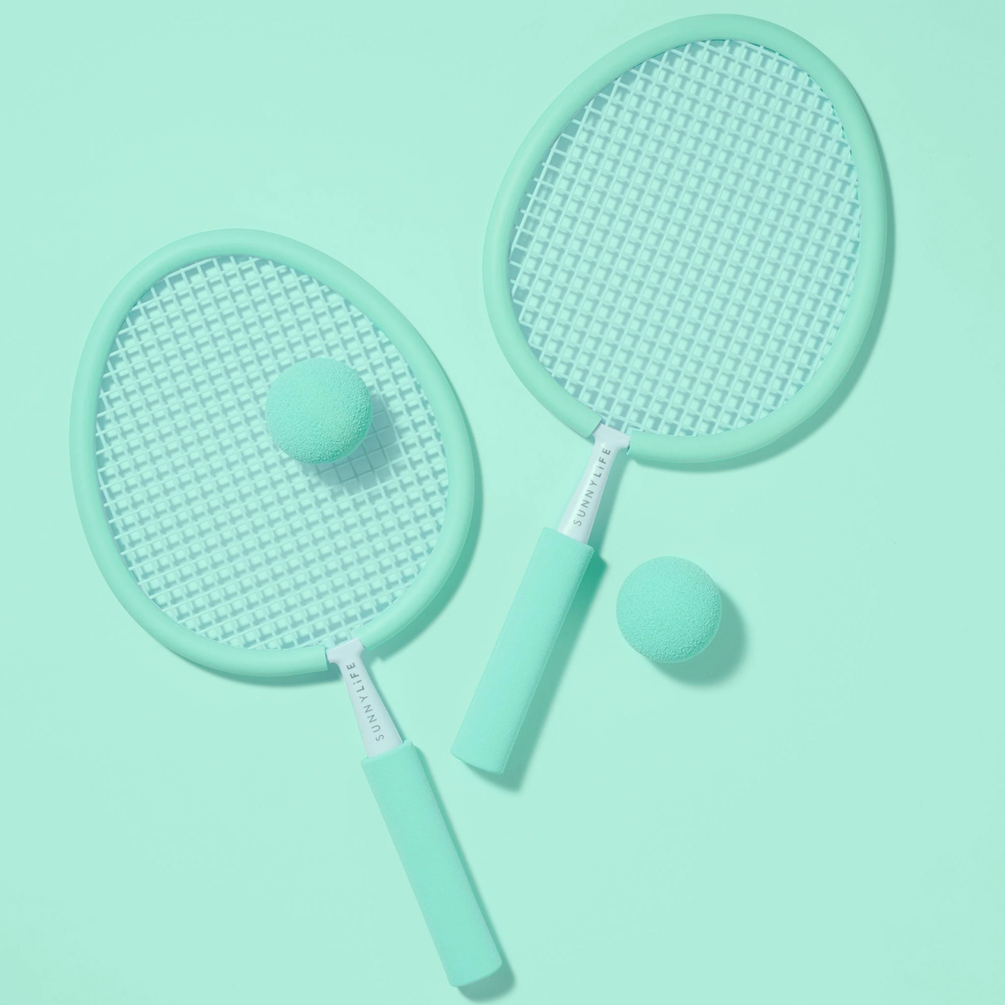 A pair of aqua rackets with two balls.