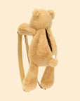 A neutral bear shaped backpack with two straps with silver details.