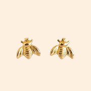 A gold pair of bee shaped earrings.