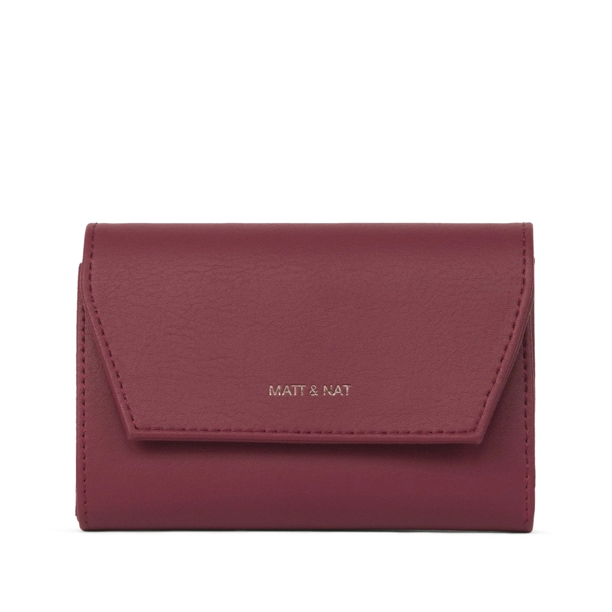 On a white background is a dark cherry red wallet. 