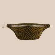 A brownish green canvas fanny pack with a black zebra stripe and polka dot interior.