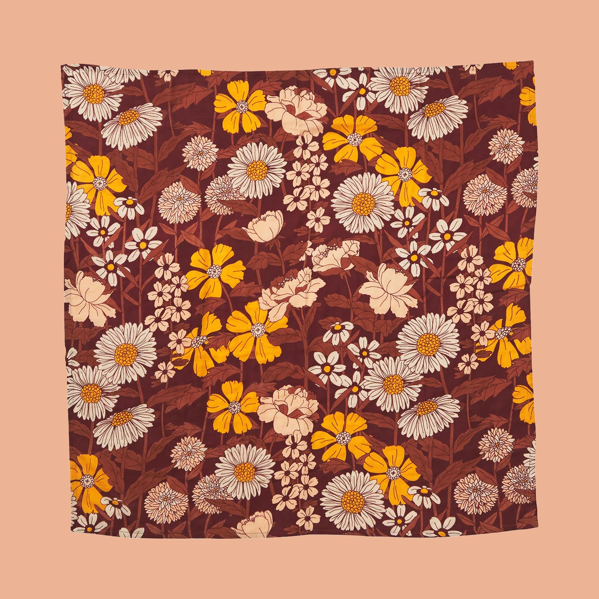 A yellow, rust and ivory floral print baby wrap blanket. 
