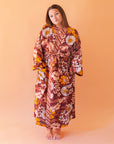 A rust, yellow and cream 70's inspired floral print linen robe.