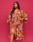 A rust, yellow and cream 70's inspired floral print linen robe.