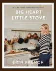 A neutral colored bookcover with a photo of a woman cooking in front of the stove with the title toward the top that reads, "Big Heart Little Stove Bringing Home Meals & Moments From The Lost Kitchen".