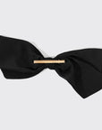A black fabric bow hair clip.