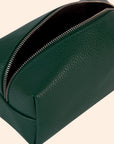 An emerald green vegan leather cosmetic case with a zipper closure.
