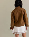 A brown suede jacket with front pockets.