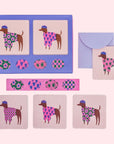 A set of mini note cards with dogs on it in different sweaters and berets, envelopes and stickers.