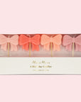 A set of four bow shaped birthday candles.